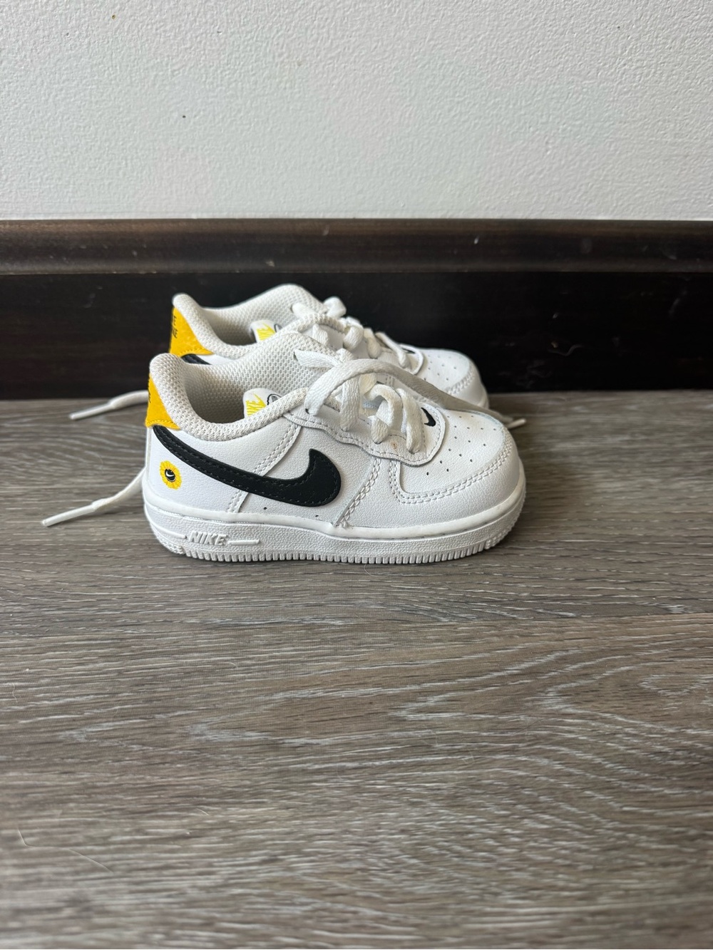 Nike Kids White Sneakers with Black Swoosh and Yellow Heel
